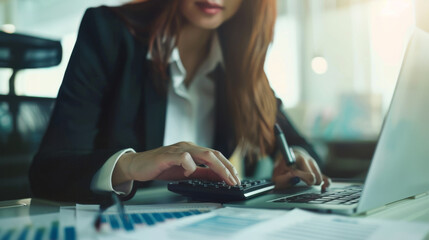 Poster - A close-up view of hands typing on a laptop keyboard, with a desk lamp illuminating the workspace.