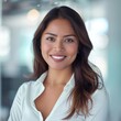 Smiling Hispanic businesswoman 30-40 years old, active business woman in front of her office