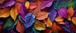 A vibrant assortment of purple, magenta, and electric blue leaves form a beautiful pattern on the ground, creating a colorful display reminiscent of a flower art event
