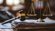Close-up of a wooden gavel on legal documents with scales of justice, blurred background