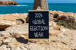 2024 global election year symbol. Concept words 2024 global election year on beautiful black blackboard. Beautiful stone blue sea sky background. Business 2024 global election year concept. Copy space