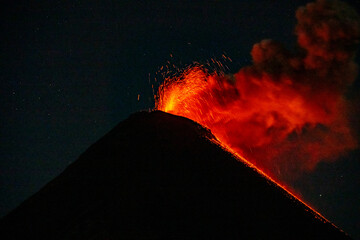 Volcan de Fuego erupting at night seen from Volcan de Acatenango.