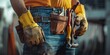 Close up of a maintenance worker with tool kits on the waist standing in front of rough wall, portrait of man at work.