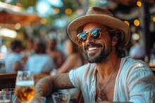 A Tattooed Man With A Straw Hat Sits At A Bar Enjoying A Chilled Drink On A Sunny Day, Surrounded By People