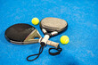  rackets paddle with two balls on blue background