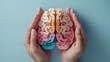 © Mahnoor - International Parkinson's awareness month concept, 3d pastel color brain illustration in human hands, Alzheimer awareness day, dementia diagnosis,April 11. Poster, banner, card, background.