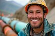 Portrait of smiling professional gas industry engineer wearing safety uniform and hard hat. Smiling confident worker at gas pipeline construction.
