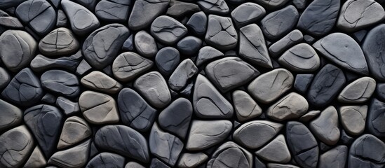 Poster - A close up of a pile of grey bedrock stones on a wall, showcasing the symmetry and pattern of the composite building material used for the road surface art