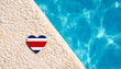Costa Rica flag in the shape of a heart near the pool in the hotel. Holiday concept in Costa Rica