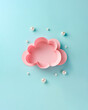 A pink paper cloud and pearl rain drops , creative aesthetic weather forecast