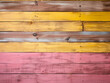 Wooden wall texture with alternating yellow and pink lines.