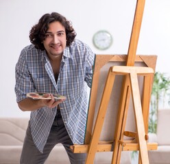 Canvas Print - Young handsome man enjoying painting at home