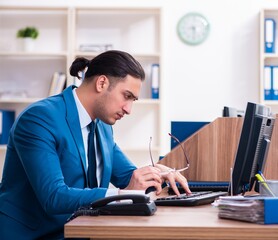 Poster - Young handsome businessman sitting in the office