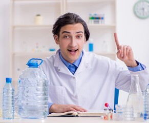 Wall Mural - Young male chemist experimenting in lab