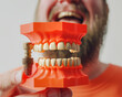 Close-up of a man with a prosthetic teeth. Dentistry concept