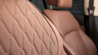Part of leather car headrest seat details. Сlose-up brown  perforated leather car seat. Skin texture