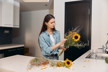 Wall Mural - Fresh and Healthy: Young Caucasian Woman Preparing a Vegetarian Salad in a Modern Kitchen