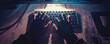 Hacker's hands on a keyboard, stolen identities on the screen