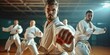 Men engaging in karate training at fitness studio, practicing fight club workout at gym and studying dojo moves as exercise at sports center. Physically active individuals displaying, Generative AI