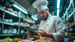© mikhailberkut - Professional Chef Using Tablet in Commercial Kitchen