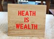 Wood stand with text written  HEALTH is WEALTH - Concept of work life balance - health is valuable that investing in wellness now will help you in the future