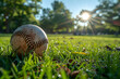 Sunset-lit baseball on grass field. Summer evening sports and leisure concept with a warm, nostalgic atmosphere