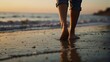 Golden Hour Beach Scene: Woman's Feet Strolling on Sand at Sunset