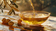 Golden olive oil flows into a glass bowl with olives and a branch in the background.