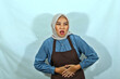 young housewife woman in hijab and brown apron, Having abdominal pain, put hands on stomach on white background. People housewife muslim lifestyle concept
