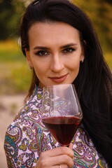 Canvas Print - Sexy, young, attractive girl, woman, with a glass of red wine on a background of nature and sunset.