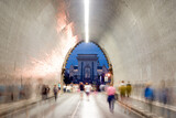 Fototapeta Uliczki - Tunnel with people in motion blur