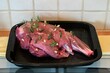 A leg of lamb is prepared for the oven. 