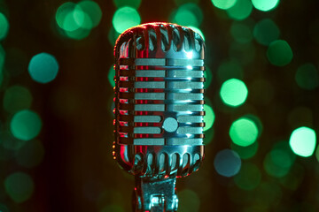 Wall Mural - Retro microphone against blurred lights, closeup