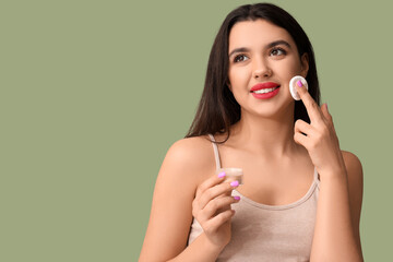 Poster - Beautiful young happy woman with powder on green background