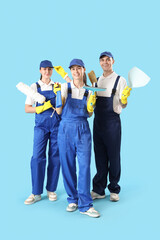 Poster - Workers of cleaning service with supplies on blue background