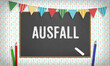 Ausfall (German for cancelled school) message on bright school education background