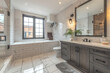 A large bathroom with grey wood cabinets, white tiles on the walls and floor, vintage sink, window, and bathtub in an industrial style home in Montreal. Created with Ai