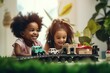 Happy laughing cute little african american children siblings playing with toy railway road, sitting on comfortable floor carpet, enjoying leisure playtime together at home, daycare concept