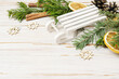 Traditional Christmas decorations with tiny wooden sledge, fir garland and dried oranges.