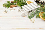 Fototapeta Kwiaty - Traditional Christmas decorations with tiny wooden sledge, fir garland and dried oranges.