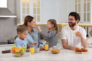 Sticker - Happy family having breakfast at table in kitchen