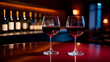 Two red wine glass and collection of wines on the background in the wine bar