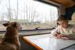 © Arianne - Boy and his dog inside a motorhome