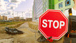Stop sign in hand of builder. Construction site. Worker reports termination of construction. Travel restriction sign. Cropped man shows stop sign. Stopping construction to lay electrical cables