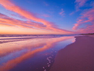 Wall Mural - seascape during sunrise. bright clouds on the sky. lines of sand on the seashore. bright sky during 