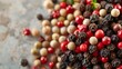 A detailed close-up of a handful of peppercorns their varied hues and round shapes standing out against a bright