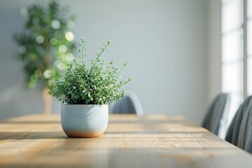 Wall Mural - Close-up view of the dining table in the dining area of a minimalist loft, with a plant accent. A small potted plant is placed on the wooden table, adding a touch of greenery to the space. 