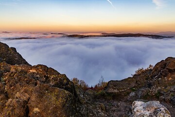 Wall Mural - Scenic mountainous landscape hidden in a sea of clouds. Kremnica Mountains, Slovakia.