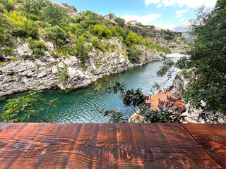 Empty table overlooking a summer cafe on the banks of the Moraca River in Montenegro