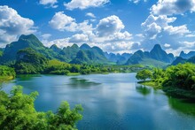 Majestic Karst Mountains Over A Calm Lake - Stunning Landscape Of Karst Mountains Towering Over A Peaceful Lake With Vibrant Green Foliage Under A Clear Blue Sky
